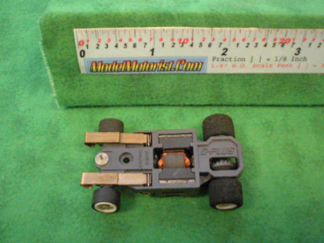 Bottom view of Aurora AFX G-Plus Narrow Fixed Axle Slot Car Chassis